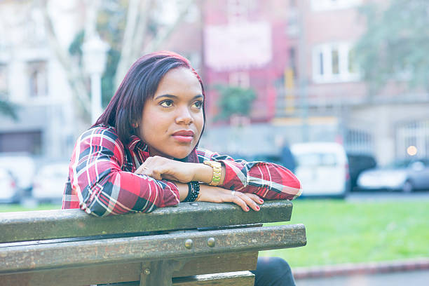 istock Young woman thinking and looking away in the park. 498691102