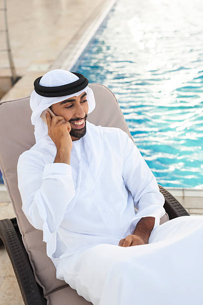 istock Emirati Man Enjoying Vacation by the Poolside 498691912