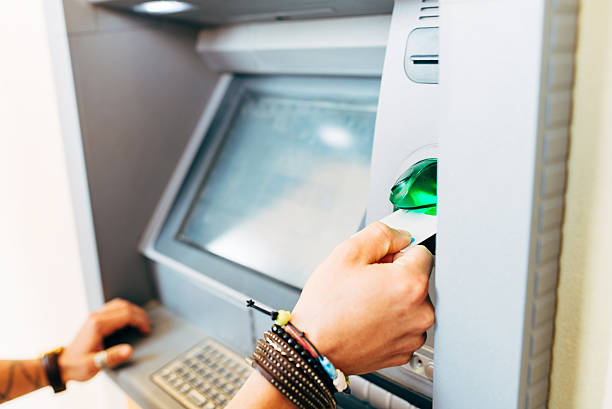 istock Man Withdraws Money From An Atm 498691940