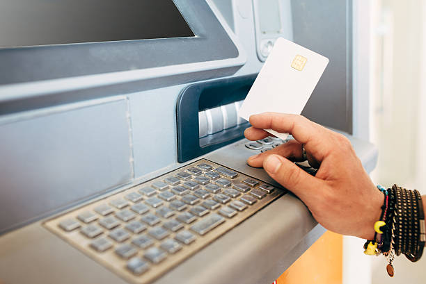 istock Man Withdraws Money From An Atm 498692504