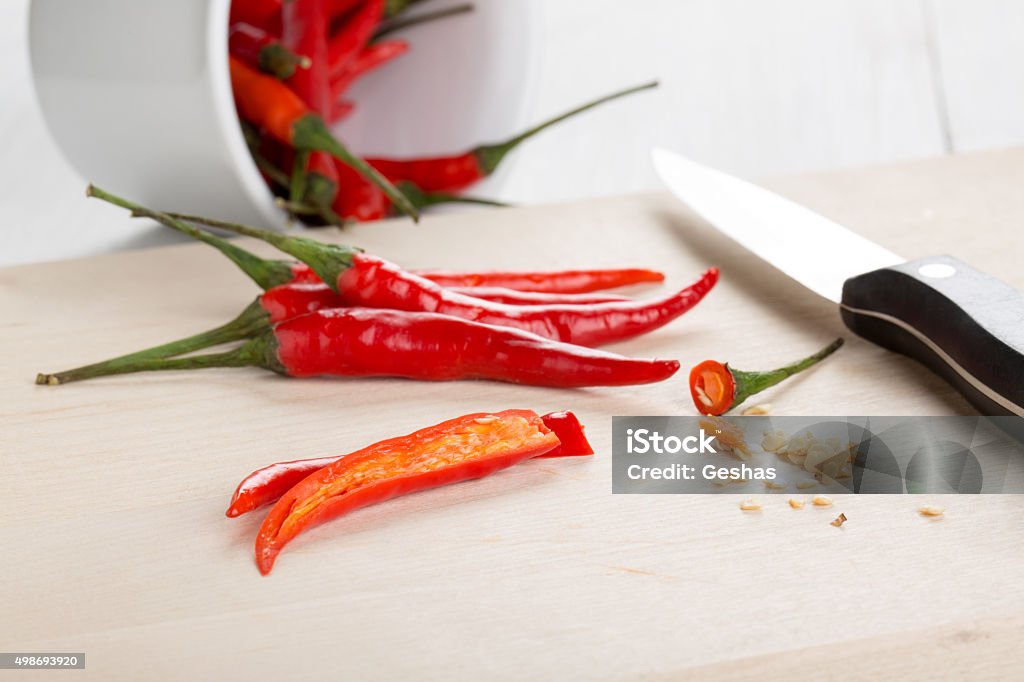 Chili peppers Red cayenne pepper. Deseed hot chili peppers before chopping. 2015 Stock Photo
