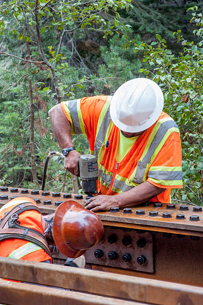 istock Hardhat Steelworkers Attaching bolts with an Impact Wrench 498695054