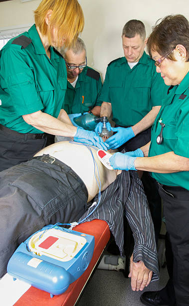 istock Paramedic nurses administer defibulator or defibrillator to revive a patient 498695564