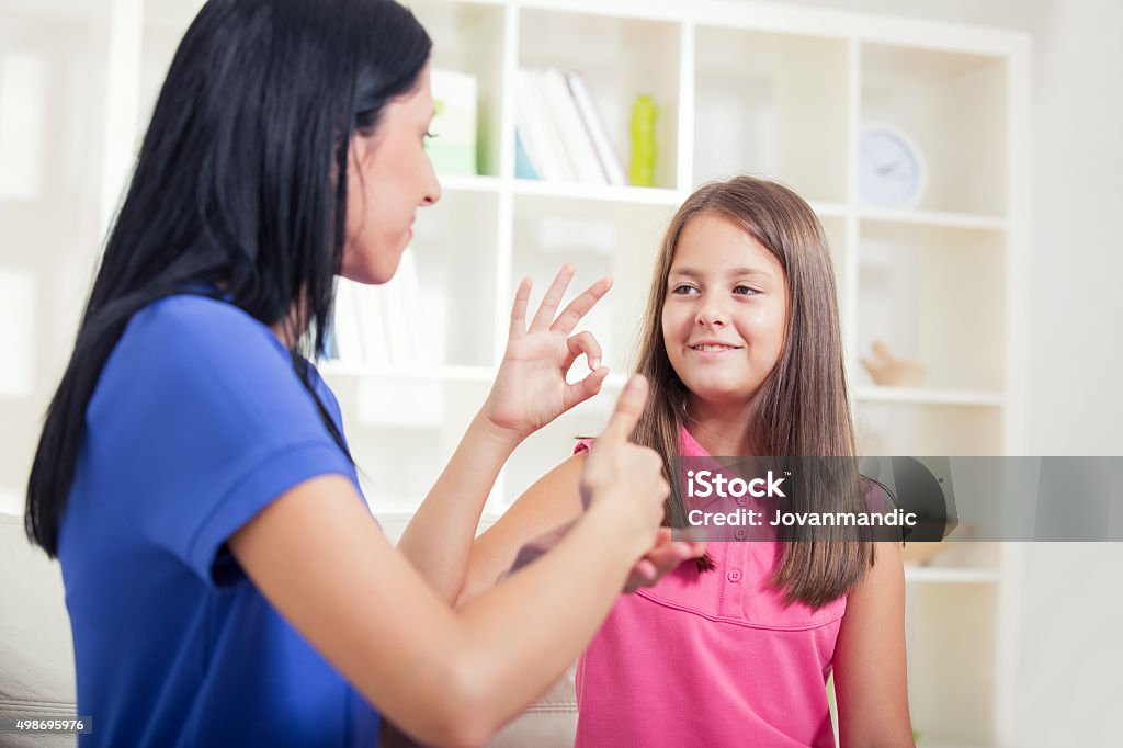 Deaf woman and child learning sign language Sign Language Stock Photo