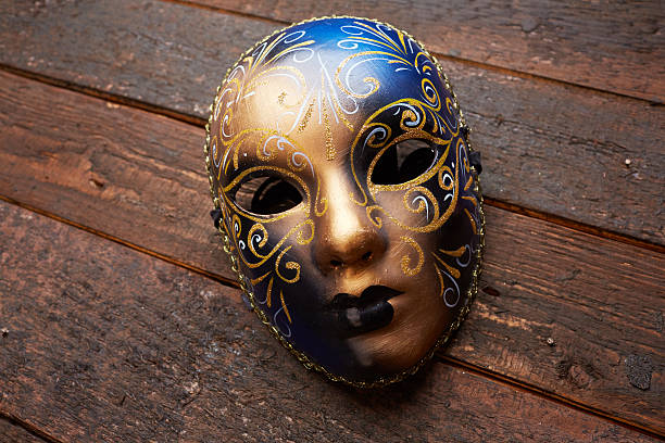 istock Venetian mask on a wooden table 498696010