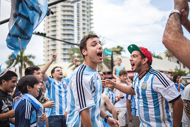 Argentinian soccer fans celebrating - Stock Image MIAMI BEACH, USA - June 21, 2014: Argentinian fans celebrating the victory on the World Cup Group F game between Argentina and Iran in the streets of Miami Beach, Florida. argentinian ethnicity photos stock pictures, royalty-free photos & images