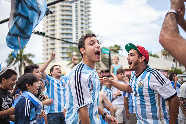 Argentinian soccer fans celebrating - Stock Image MIAMI BEACH, USA - June 21, 2014: Argentinian fans celebrating the victory on the World Cup Group F game between Argentina and Iran in the streets of Miami Beach, Florida. argentinian ethnicity stock pictures, royalty-free photos & images