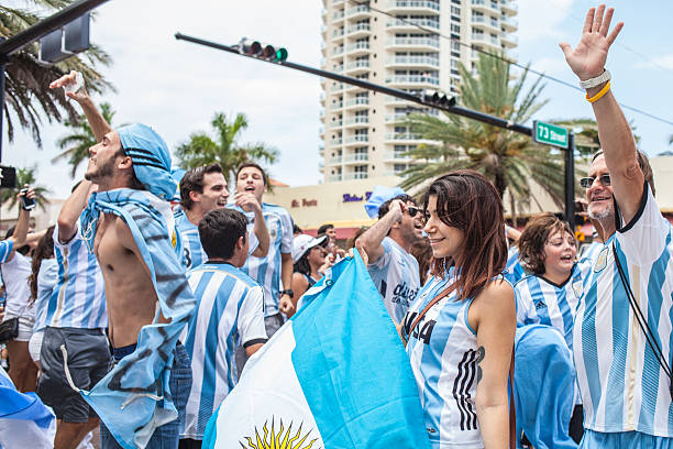 Argentinian soccer fans celebrating - Stock Image MIAMI BEACH, USA - June 21, 2014: Argentinian fans celebrating the victory on the World Cup Group F game between Argentina and Iran in the streets of Miami Beach, Florida. football2014 stock pictures, royalty-free photos & images
