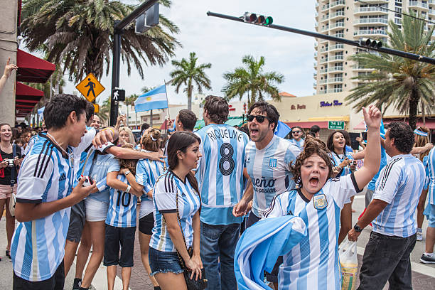 Argentinian soccer fans celebrating - Stock Image MIAMI BEACH, USA - June 21, 2014: Argentinian fans celebrating the victory on the World Cup Group F game between Argentina and Iran in the streets of Miami Beach, Florida. football2014 stock pictures, royalty-free photos & images