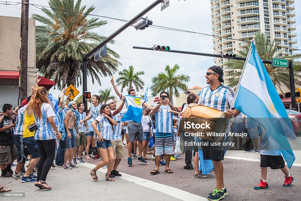 Argentinian soccer fans celebrating - Stock Image MIAMI BEACH, USA - June 21, 2014: Argentinian fans celebrating the victory on the World Cup Group F game between Argentina and Iran in the streets of Miami Beach, Florida. Argentina Stock Photo