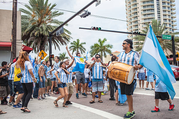 Argentinian soccer fans celebrating - Stock Image MIAMI BEACH, USA - June 21, 2014: Argentinian fans celebrating the victory on the World Cup Group F game between Argentina and Iran in the streets of Miami Beach, Florida. football2014 stock pictures, royalty-free photos & images