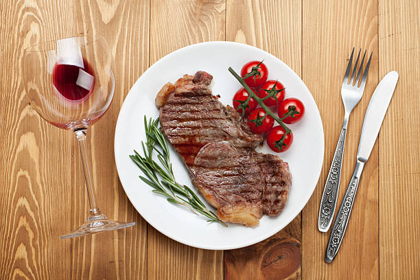 istock Sirloin steak with rosemary and cherry tomatoes on a plate 498704407