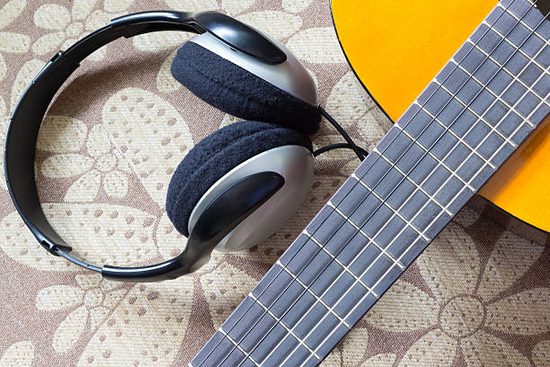 istock acoustic guitar and headphone on fabric flower pattern sofa 498704783