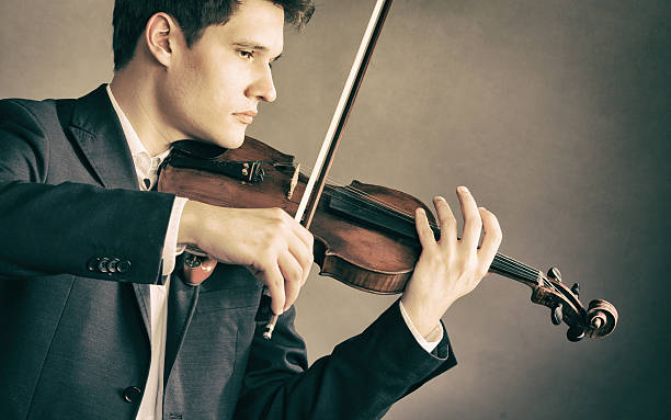 istock Man violinist playing violin. Classical music art 498705491