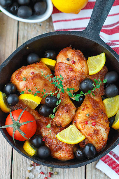 istock Fried chicken. Fried chicken legs with lemon and olives 498708280