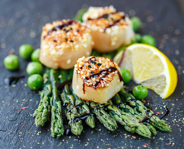 istock Scallops with sesame seeds, balsamic sauce and  asparagus 498708300