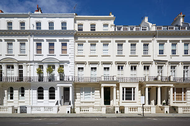 White luxury houses facades in London White luxury houses facades in London, Kensington and Chelsea architecture in a sunny day with blue sky notting hill stock pictures, royalty-free photos & images