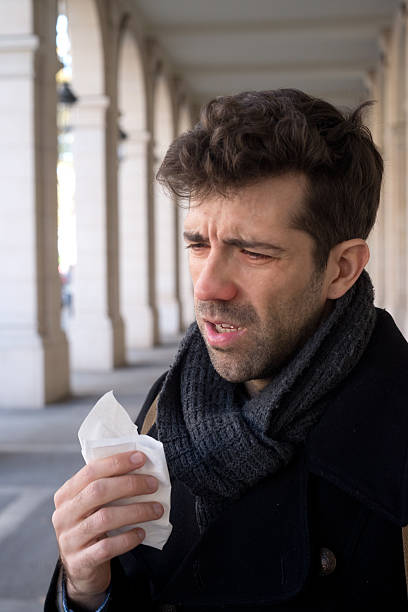 istock Man sneeze and handkerchief 498710520