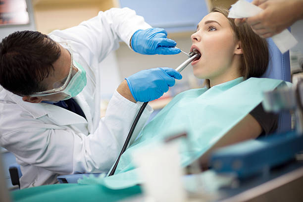Dentist put instruments in girl's mouth at ambulant Dentist put dental mirror and drill in patient mouth ambulant patient stock pictures, royalty-free photos & images