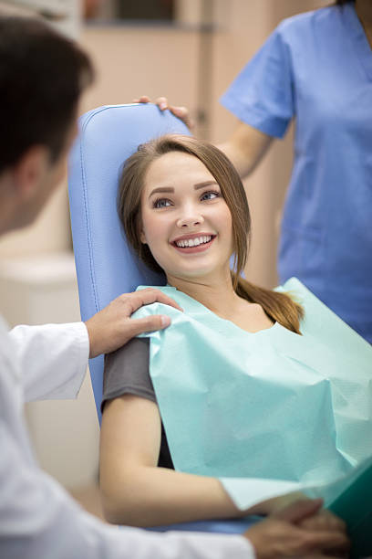 Dentist comforting patient stock photo