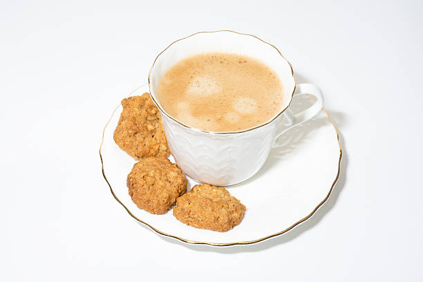 istock White cup of coffee on white background with cookies 498712546