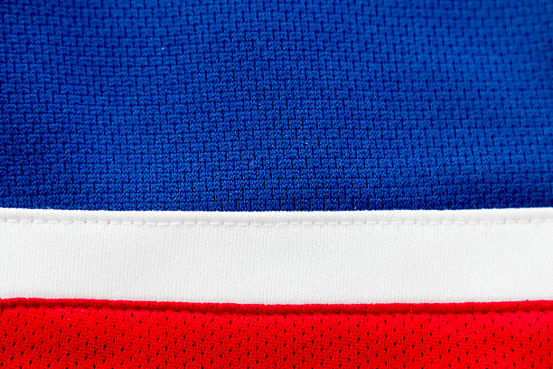 istock Blue jersey close up with red and white stripes 498713184