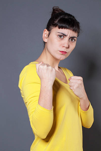 istock frowning young woman with fair skin with threatening hand gesture 498713440