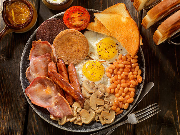 Full Traditional English Breakfast Sunny side up Eggs with Blood Pudding, Sausage, Bacon, Beans, Mushrooms, Toast and Tomatoes-Photographed on Hasselblad H3D-39mb Camera english breakfast stock pictures, royalty-free photos & images