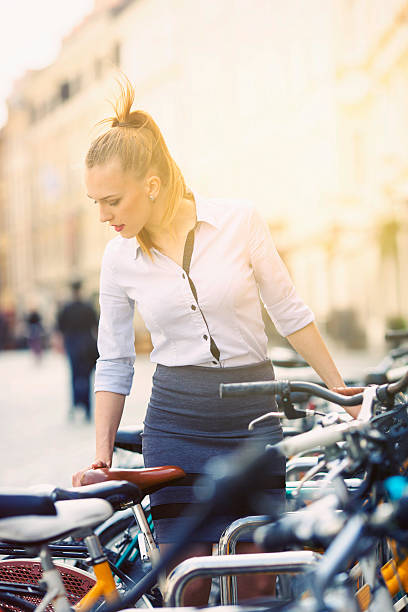 istock Young woman parking her bicycle 498717290