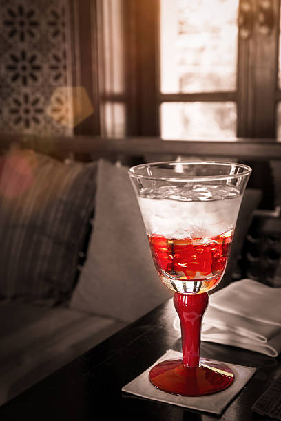 Red Glass Of Water On The Table With Sun Light : Selective Focus With Filtered Process