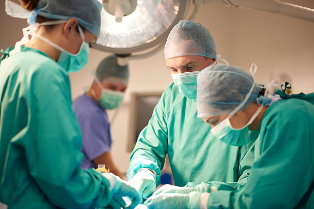 istock male and female surgeon at the operating table 498722836