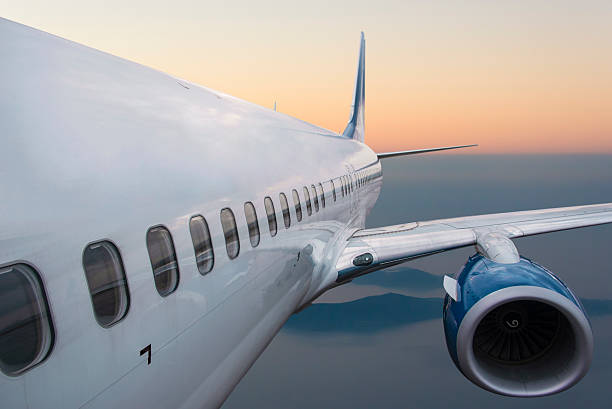 istock Body of an Airplane Flying at sunset 498722878