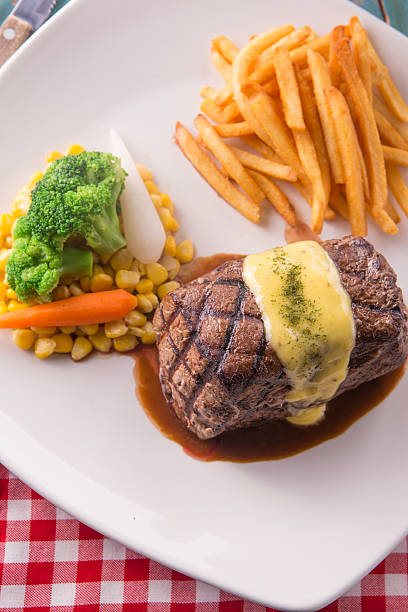 Grilled Steak served with Hollandaise sauce Grilled Steak served with Hollandaise sauce, fries, boiled corn, carrot, broccoli and red wine hollandaise sauce stock pictures, royalty-free photos & images