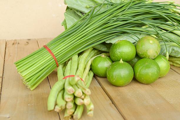 istock green Lime Yardlong bean Leek and kale on wood floor 498723174