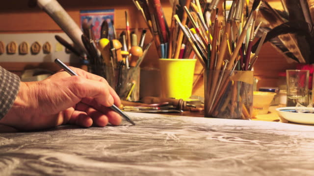 Male artist's hand sketching something