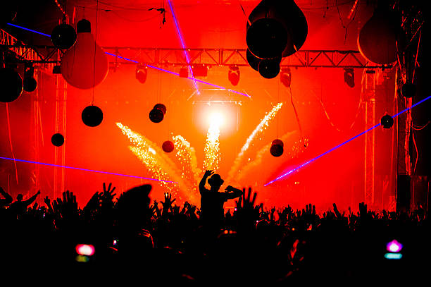 Pyrotechnics hands in the air silhouette Hands in the air silhouette payrotechnics at edm party festival. dance & electronic music stock pictures, royalty-free photos & images