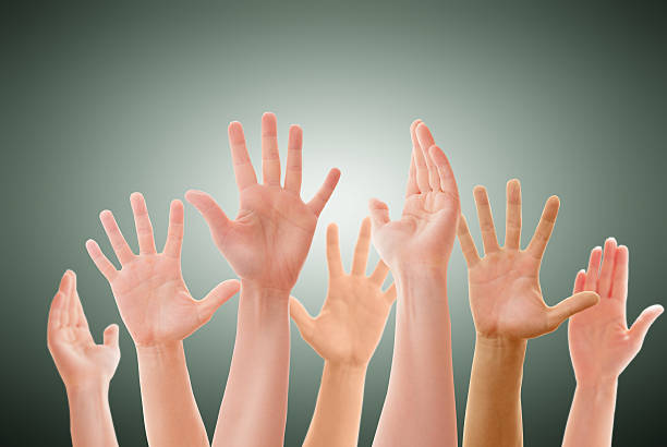 istock Raised up hands of many people isolated 498733033
