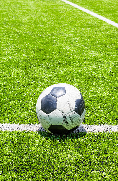 istock Soccer ball on green field 498733147