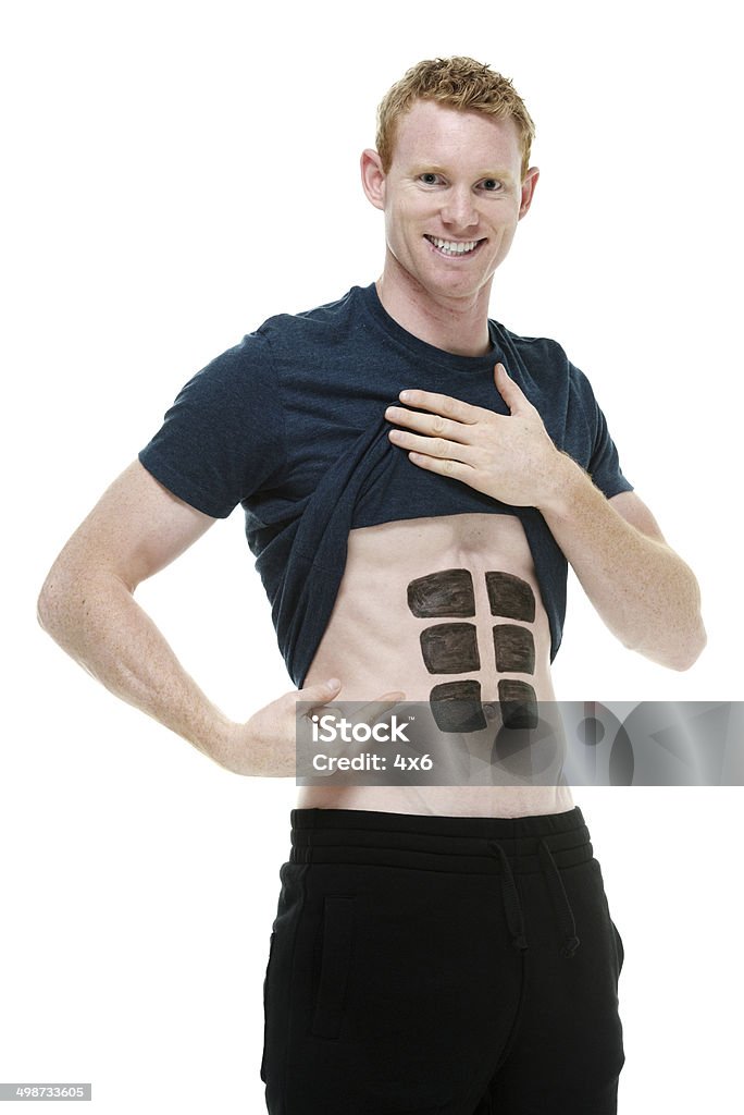 Man showing his falsa seis de los músculos - Foto de stock de 20 a 29 años libre de derechos