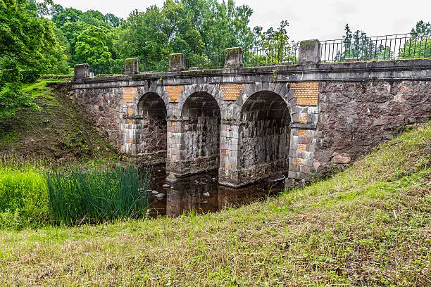 old stone bridge in a small quiet park