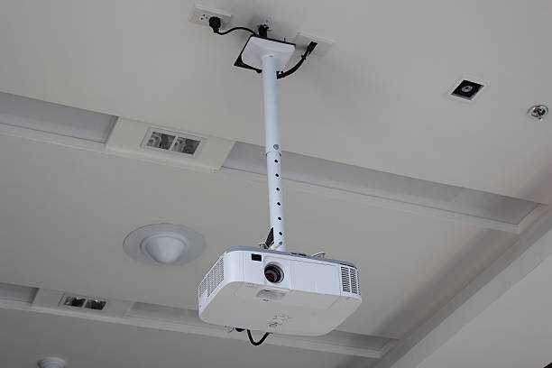 Projector hang on ceiling in meeting room stock photo