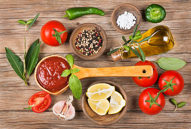 istock Olive oil, vegetables and spices on a brown background 498736107