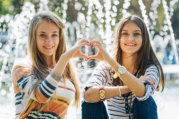 istock Best friends making heart sign 498736482