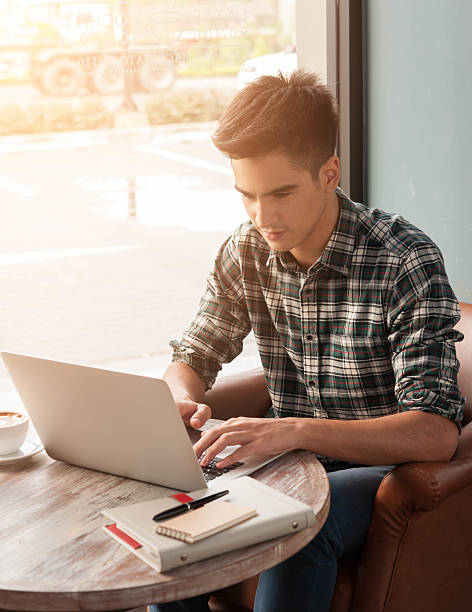 istock Businessman using laptop with tablet and pen on wooden table 498738000