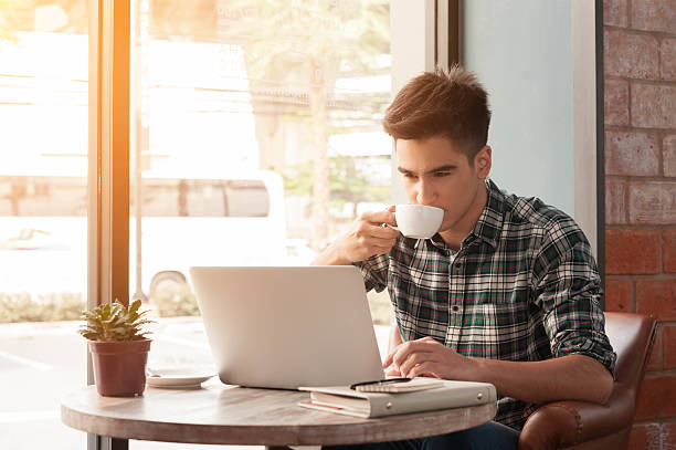 istock Businessman using laptop with tablet and pen on wooden table 498738198