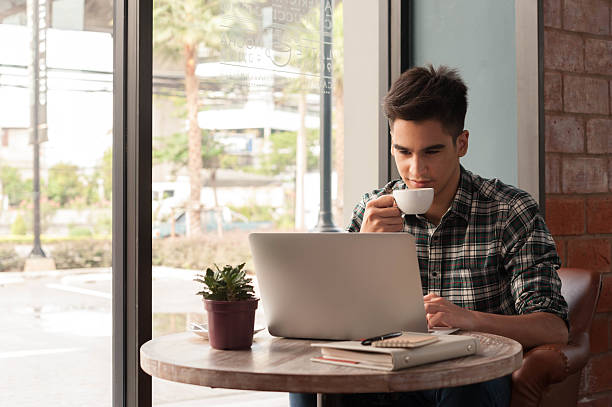 istock Businessman using laptop with tablet and pen on wooden table 498738642