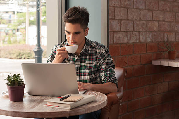 istock Businessman using laptop with tablet and pen on wooden table 498738690