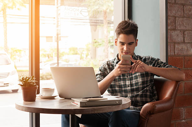istock Businessman using laptop with tablet and pen on wooden table 498739084
