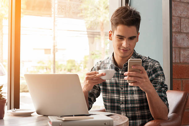 istock Businessman using laptop with tablet and pen on wooden table 498739276