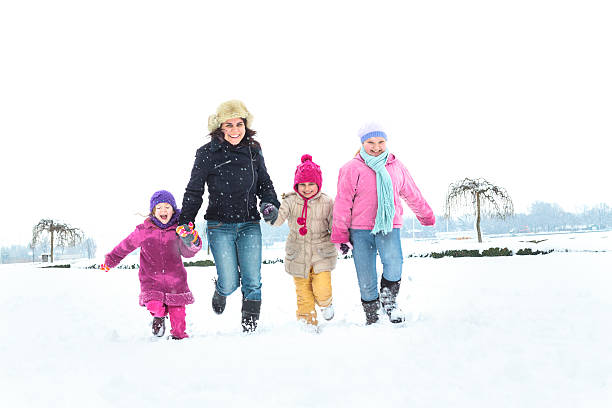 istock Cute family having fun in the snow 498741150